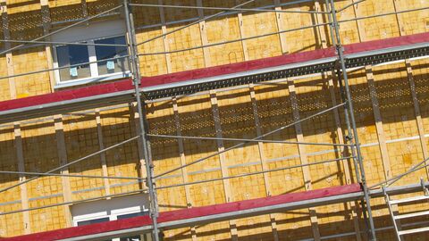 Mietshaus mit Baugerüst und neuer Isolierung an der Außenfassade Mietshaus mit Baugerüst und neuer Isolierung an der Außenfassade