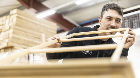 Eine Person geht einem Holzhandwerk nach.