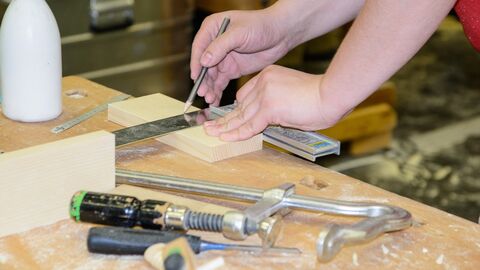 Eine Person arbeitet an einer Handwerksbank