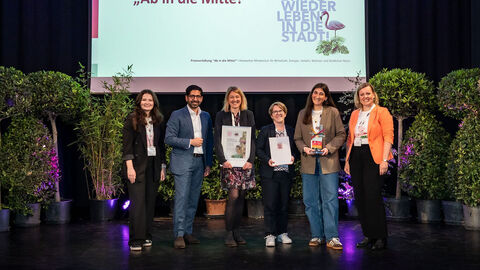 Mehrere Personen stehen auf einer Bühne