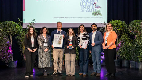 Mehrere Personen stehen auf einer Bühne