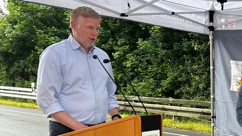 Ein Mann hält eine Rede an einem Stehpult